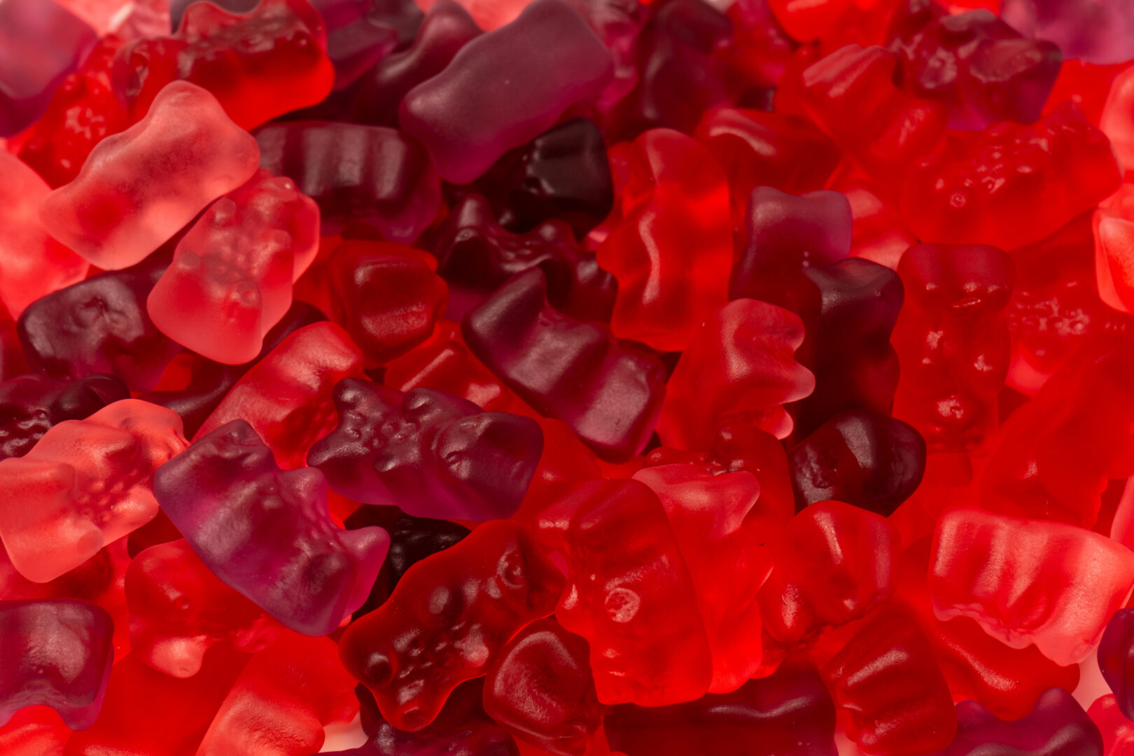 Assorted red gummy candies. Jelly bears.